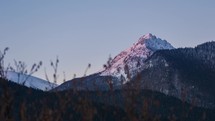 Morning sunlight colors in mountain peak at sunrise. Time lapse dolly shot
