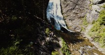 people hiking to look at a waterfall 