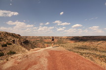 a woman hiking a desert landscape 