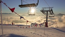 Empty chairlift in alpine mountains ski resort in beautiful sunny morning nature in winter skiing season
