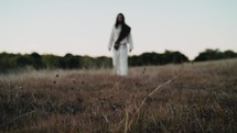 Jesus walking through a field 