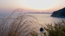 Sun rising over sea on an island