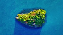 Small island in the blue sea. Aerial paradise ocean island.	