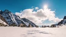 Beautiful Clouds sky time lapse in sunny winter alps mountains nature landscape
