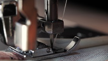 Close up of sewing machine showing process. Item of clothing, vintage style. sewing process in the phase of overstitching. Tailoring Process. Fashion concept. Macro view