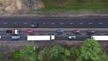 Aerial Drone Flight top down View of freeway busy city rush hour heavy traffic jam highway.