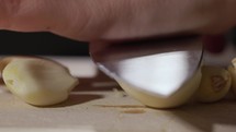 Pressing Garlic With A Kitchen Knife - Macro Shot