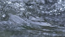 Beauty of flow crystal clear water waves in river slow motion nature
