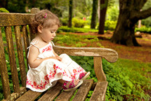 Girl sitting on park bench