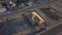 Aerial orbit of a house under construction in a new neighborhood