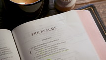 Rack focus on Bible open to Psalms