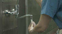 Surgeon washing his hands carefully before starting surgery.
