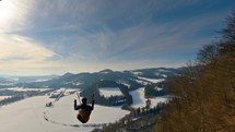 Paragliding freedom flying above forest and rocks in winter nature Follow cam High view Adrenaline adventure 
