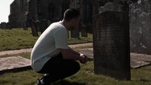 a man visiting a cemetery 