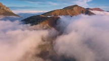 Aerial view of misty clouds in alps mountains in autumn nature. Peaceful natural background heaven dream landscape
