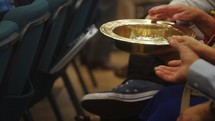 passing the offering plate during a worship service 