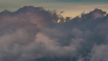 Winter mountains hidden in fast motion clouds at sunrise in frozen nature Time-lapse
