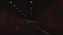 Driving through a dark tunnel in a car, road tunnel, traffic, light at the end of the tunnel