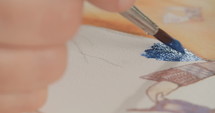 Macro shot of an artist painting with water colors and acrylics