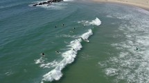 Bird's eye view of surfer carving and riding shortboard in shorebreak wave.