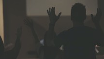 hands raised listening to worship music at a worship service 