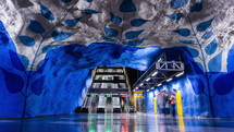 14 February 2020, Stockholm Sweden. Timelapse of underground metro station T-Centralen. Blue line with flowers on ceiling, central station with crowd of people.