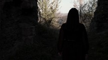 girl walking outside an ancient fortress
