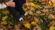 feet of a toddler boy in fall leaves 