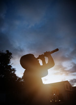 a child looking into space with a telescope 