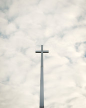 a cross against a cloudy sky