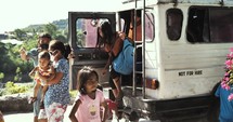 Kids going getting off the bus to school or church in the Philippines