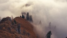 Misty mountain forest trees in sunny autumn mystic dramatic nature time lapse fast motion fog clouds
