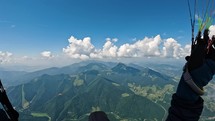 Fly high above green mountains on paragliding adrenaline adventure
