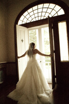 A bride opening the doors to walk outside