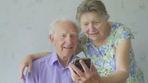 elderly caucasian couple taking a selfie 