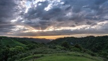 Colorful evening sunset with dramatic cluds sky over wild nature in New Zealand landscape Time lapse
