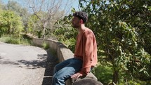 Young Boy Sitting On A Wall In A Calabrian Countryside