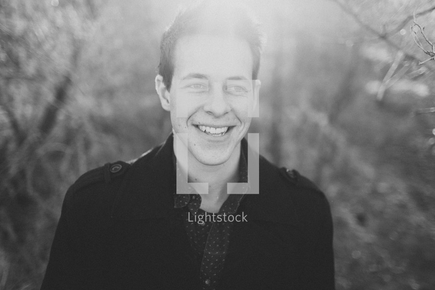 smiling man outdoors in sunlight 