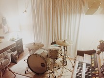 drum set and keyboard in a studio