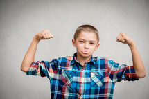 kid showing his muscles 