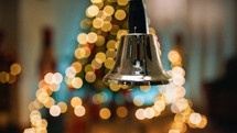 Shaking and ringing bell with blurred Christmas background