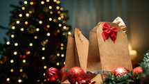 Christmas Gift Brown Bags Against Tree