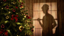 Shadow Of Man Dancing Near The Christmas tree