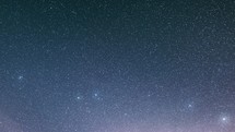 Stars background time lapse in blue night sky
