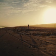 Man on a beach at sunset. 