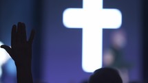 A man raising his hand in praise at a church service