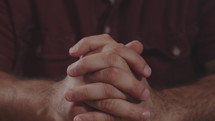 a man with praying hands 
