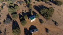 Aerial orbit of a tiny house in the rural desert
