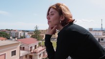 Woman Dressed In Black Looking Out From The Balcony Sees The Panorama