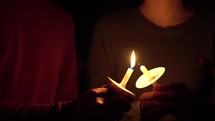 a person holding a candle at a candlelight service 